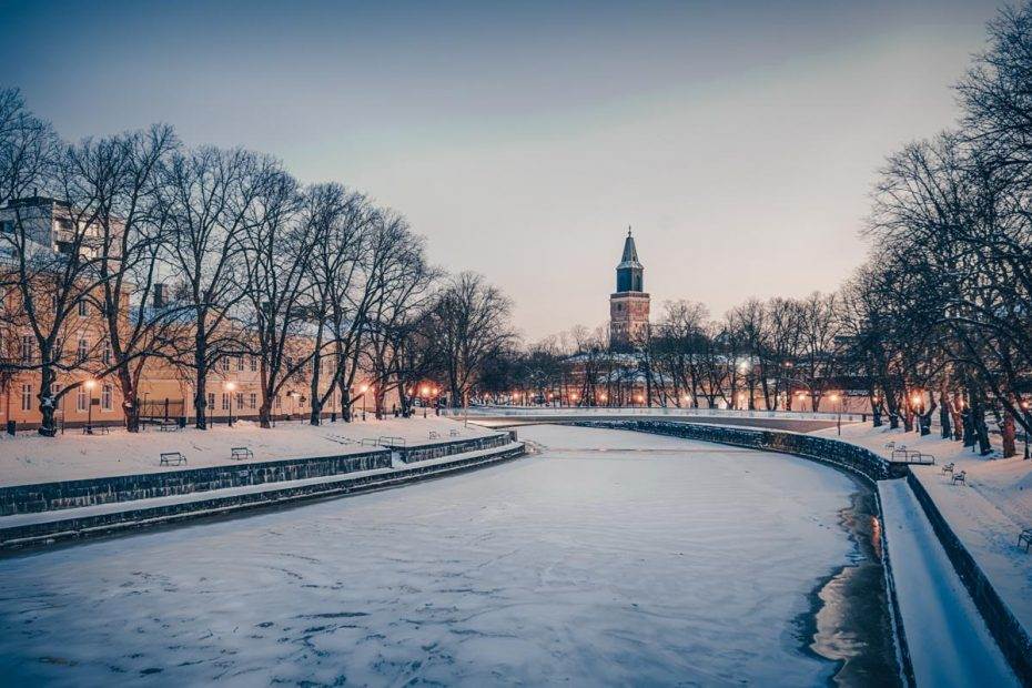 Things to do in Turku: View of the frozen Aura River and Turku Cathedral in winter