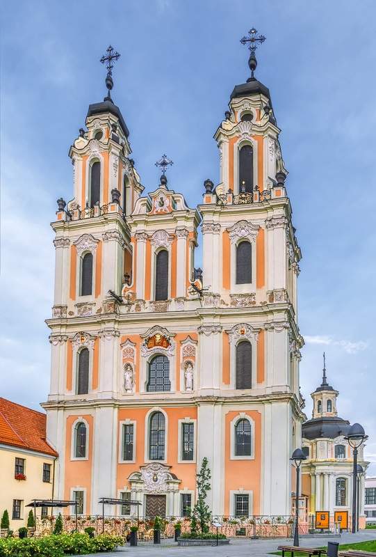 Vilnius Churches: The strawberry and cream colored Baroque style facade of the St. Catherine's Church, one of the best things to see on a self-guided Vilnius walking tour.