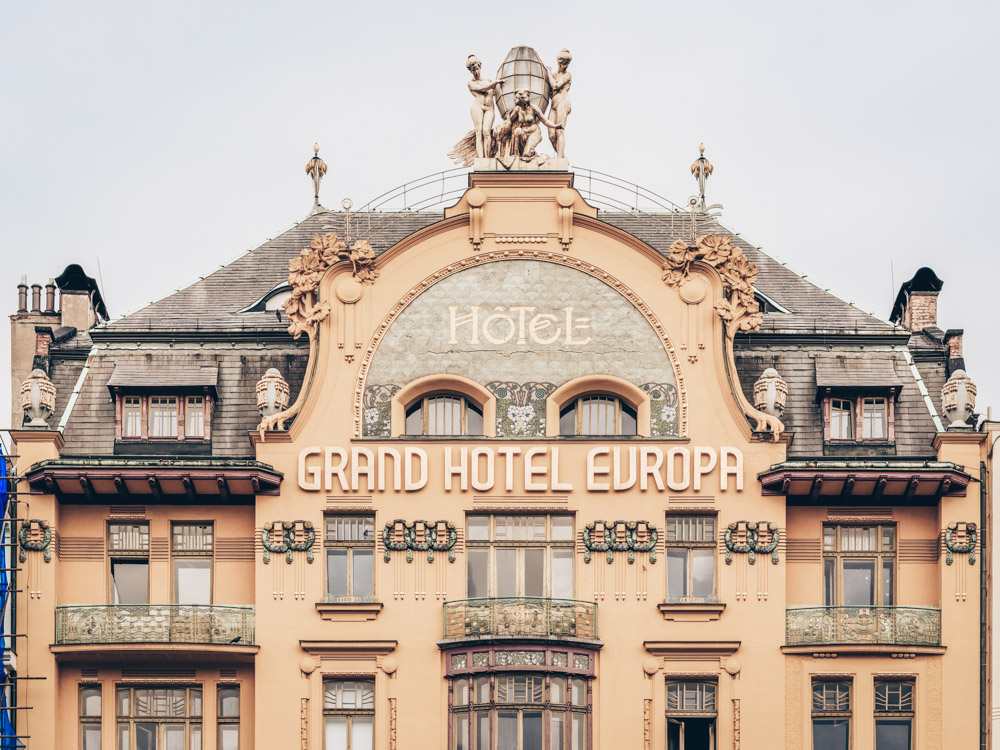 Prague architecture: View of the ornate Art Nouveau-style Grand Hotel Europa which features a splendid facade crowned with gilded nymphs. It is one of the best things to see in the New Town of Prague.