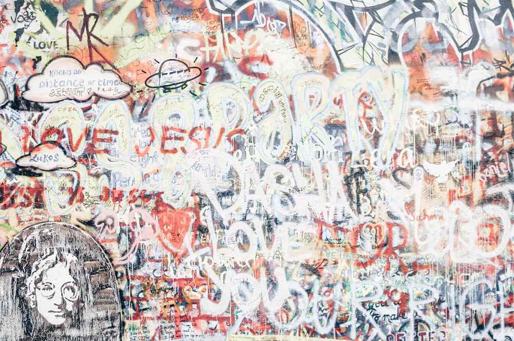 Free Prague Walking Tour: View of graffiti and messages on the Lennon Wall, dedicated as a shrine to the ex-Beatle. 