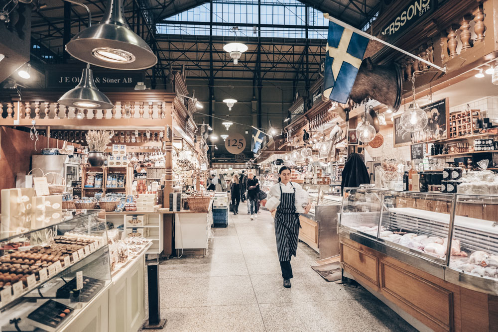 Places to visit in Stockholm: People in the interior of Östermalm Food Hall. PC: Rolf_52/shutterstock.com