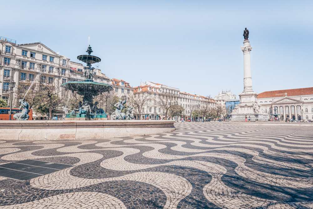 One Day in Lisbon: Wave-like mosaic pavement and ornate Baroque fountain in Rossio Square.