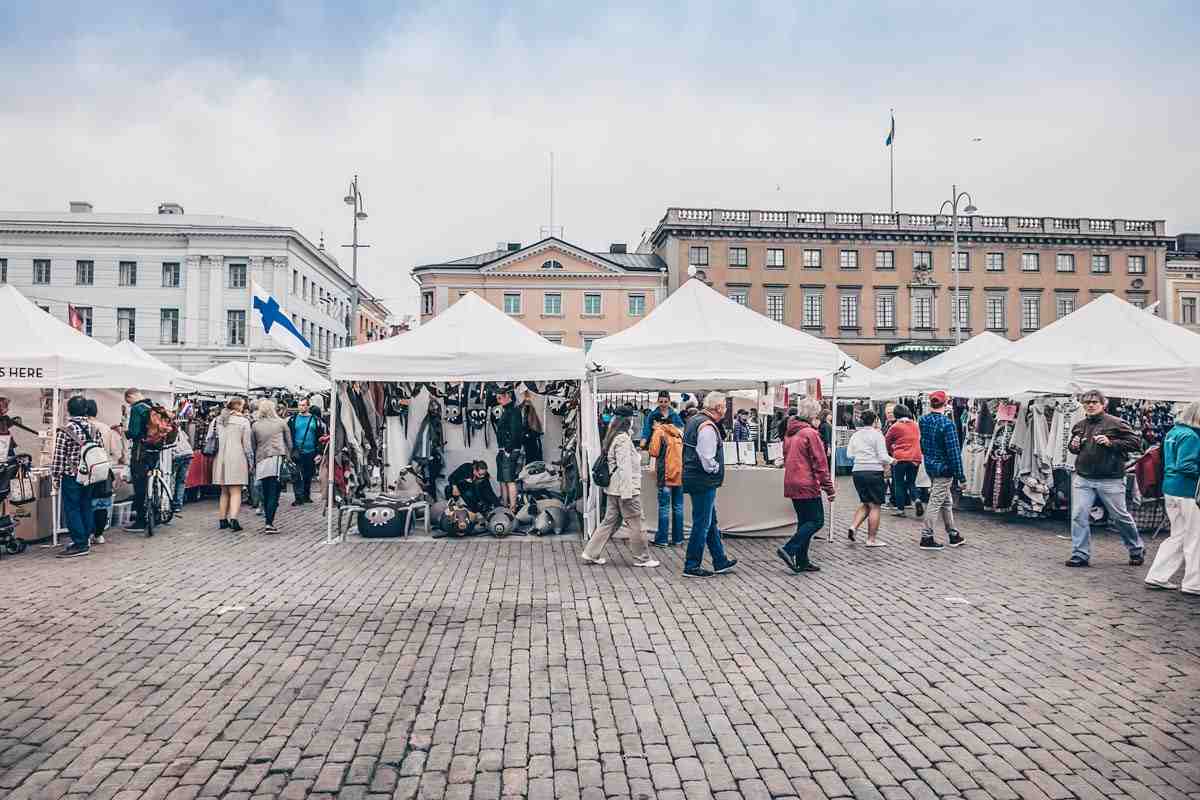 Helsinki attractions: People walking around the market stalls in Central Market Square (Kauppatori). PC: Kiev.Victor/shutterstock.com