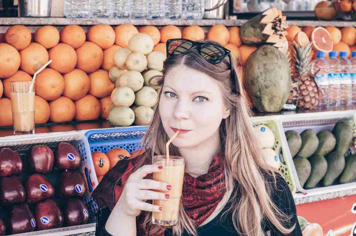 Marrakech: Beautiful blonde woman sipping orange juice in Jemaa el Fna