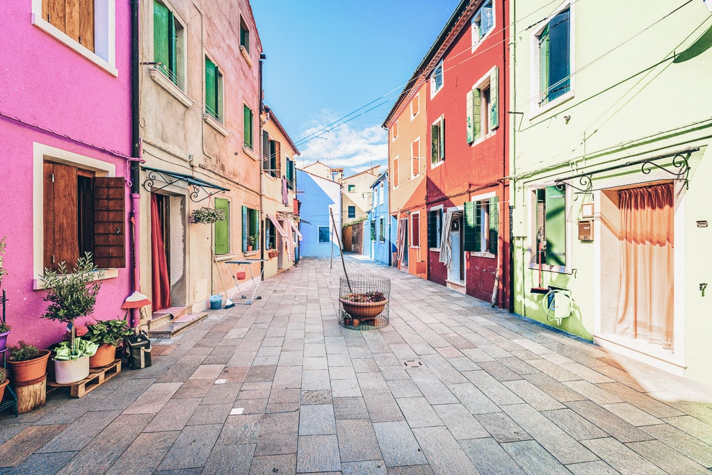 Colorful houses along a quiet street in Burano, Italy.