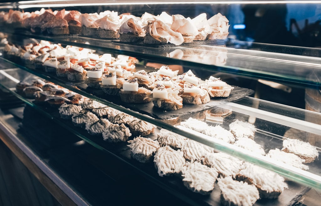 An assortment of mouthwatering cicchetti on display in a food counter in Venice.