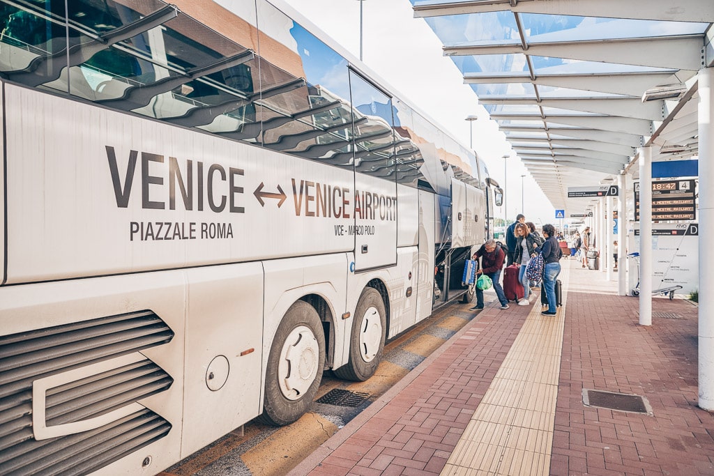 People boarding a bus leaving for Venice at Marco Polo Airport. PC: Sorbis/Shutterstock.com