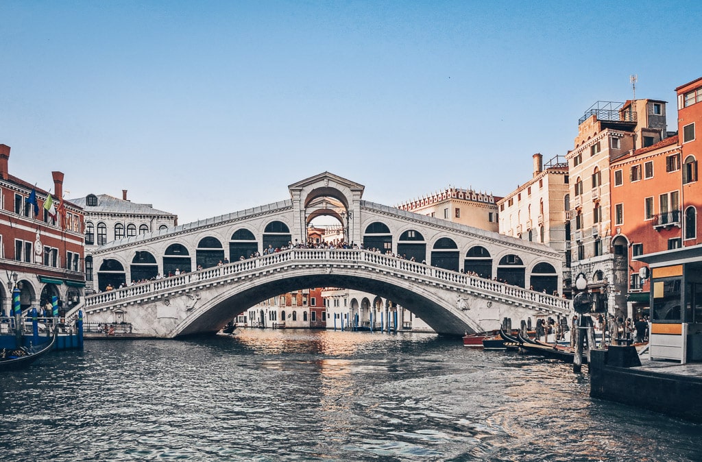 The iconic Rialto Bridge in Venice as seen from the Grand Canal during the day.
