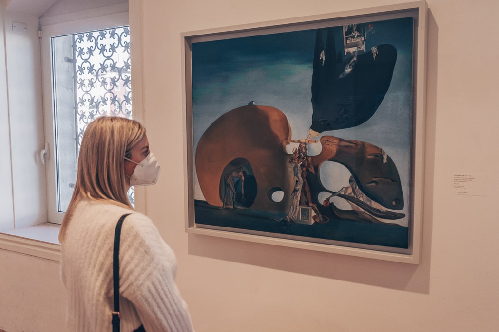 Woman admiring Salvador Dalí’s spellbinding 'Birth of Liquid Desires' at the Peggy Guggenheim Collection in Venice.