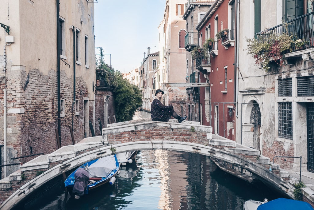 Beautiful woman posing on the lovely little Ponte Chiodo (Chiodo Bridge) in Venice.