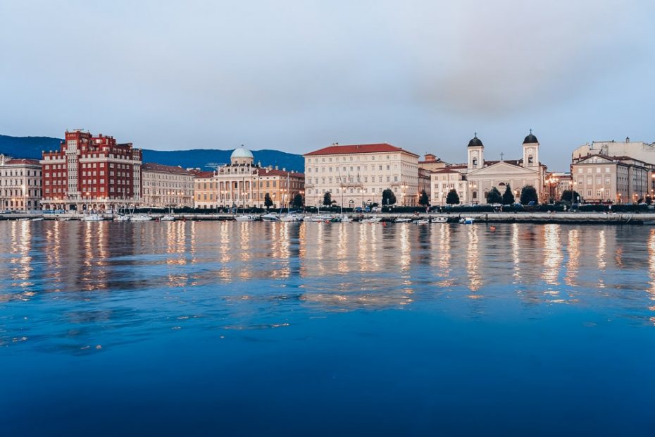 A seaside view of Trieste from the Molo Audace pier in the evening.