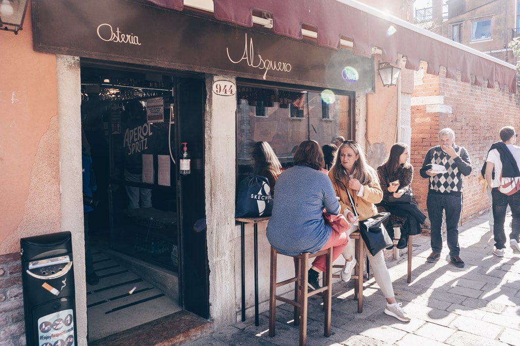 Customers seated on tables outside of Osteria Al Squero in Venice.