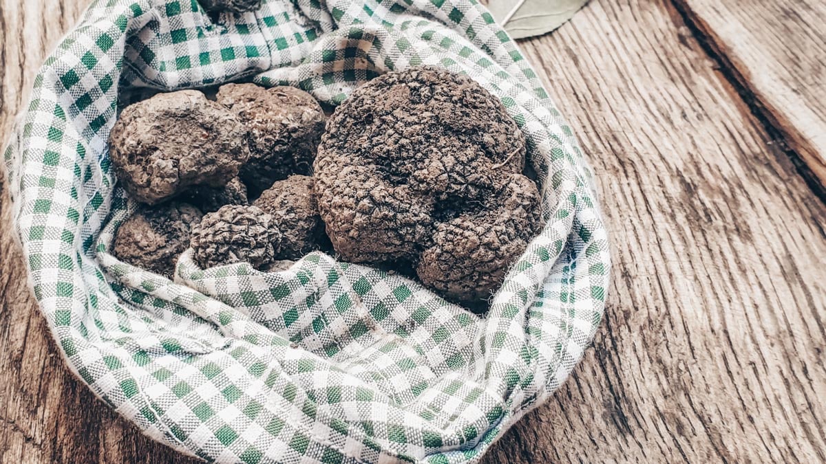 An assortment of truffles in a cloth on a wooden table