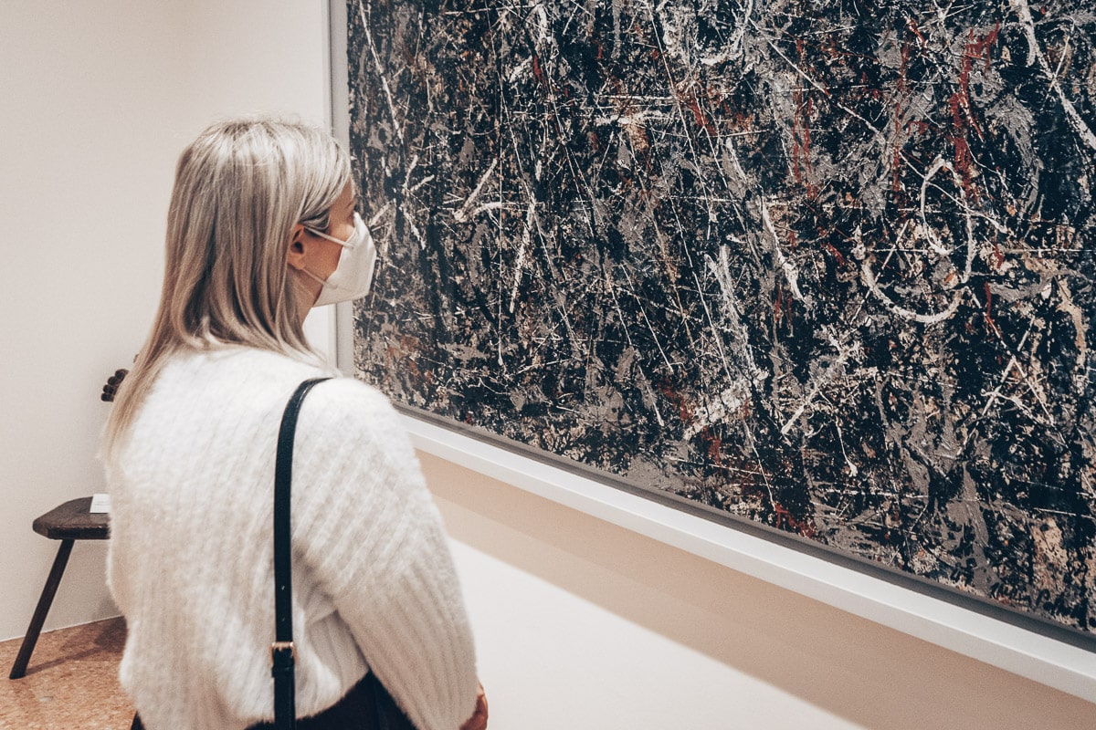 Woman admiring Jackson Pollock’s Alchemy painting at the Peggy Guggenheim Collection in Venice