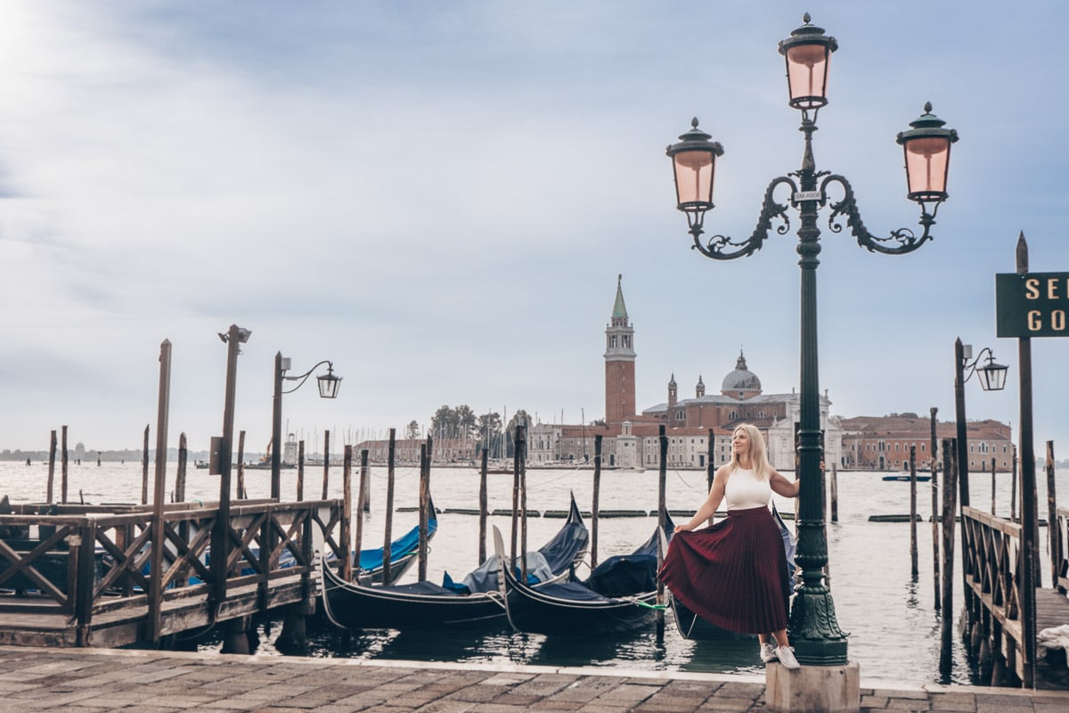 Instagrammable Venice: Woman posing by the gondolas moored along Riva degli Schiavoni