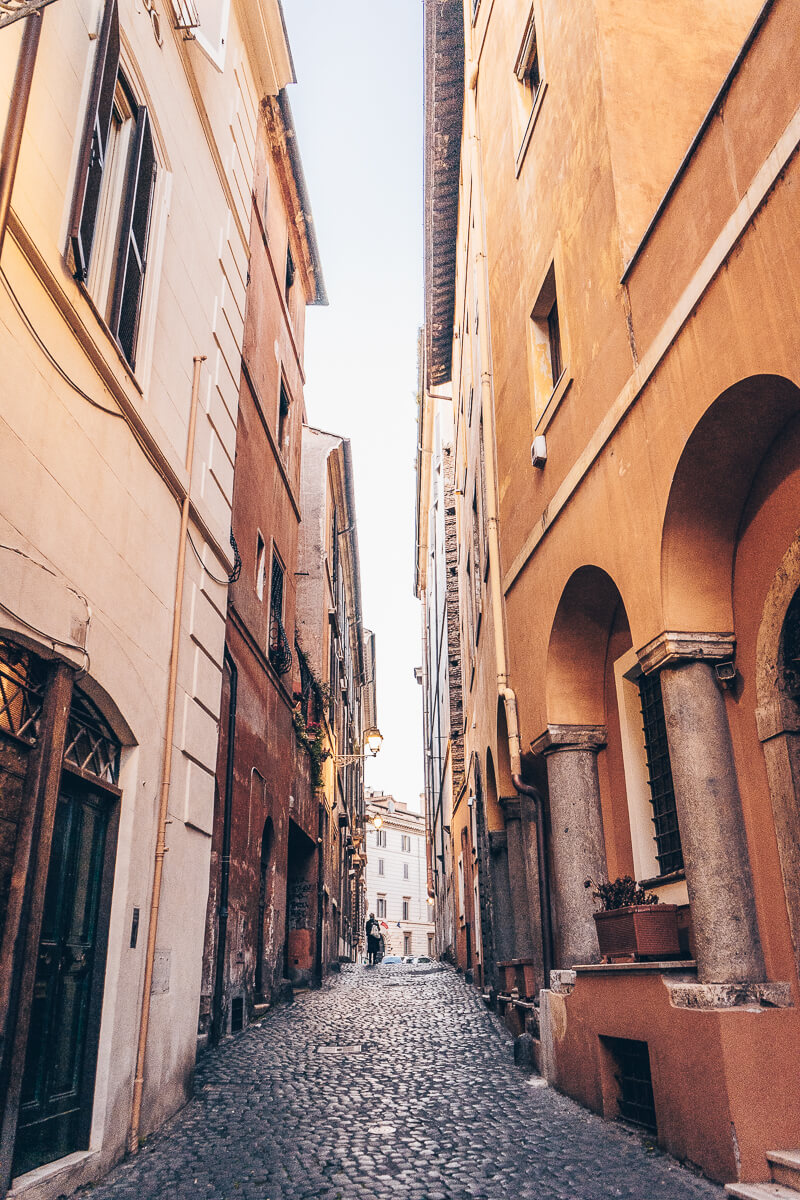 A narrow, cobblestone street in the Jewish Ghetto of Rome, Italy