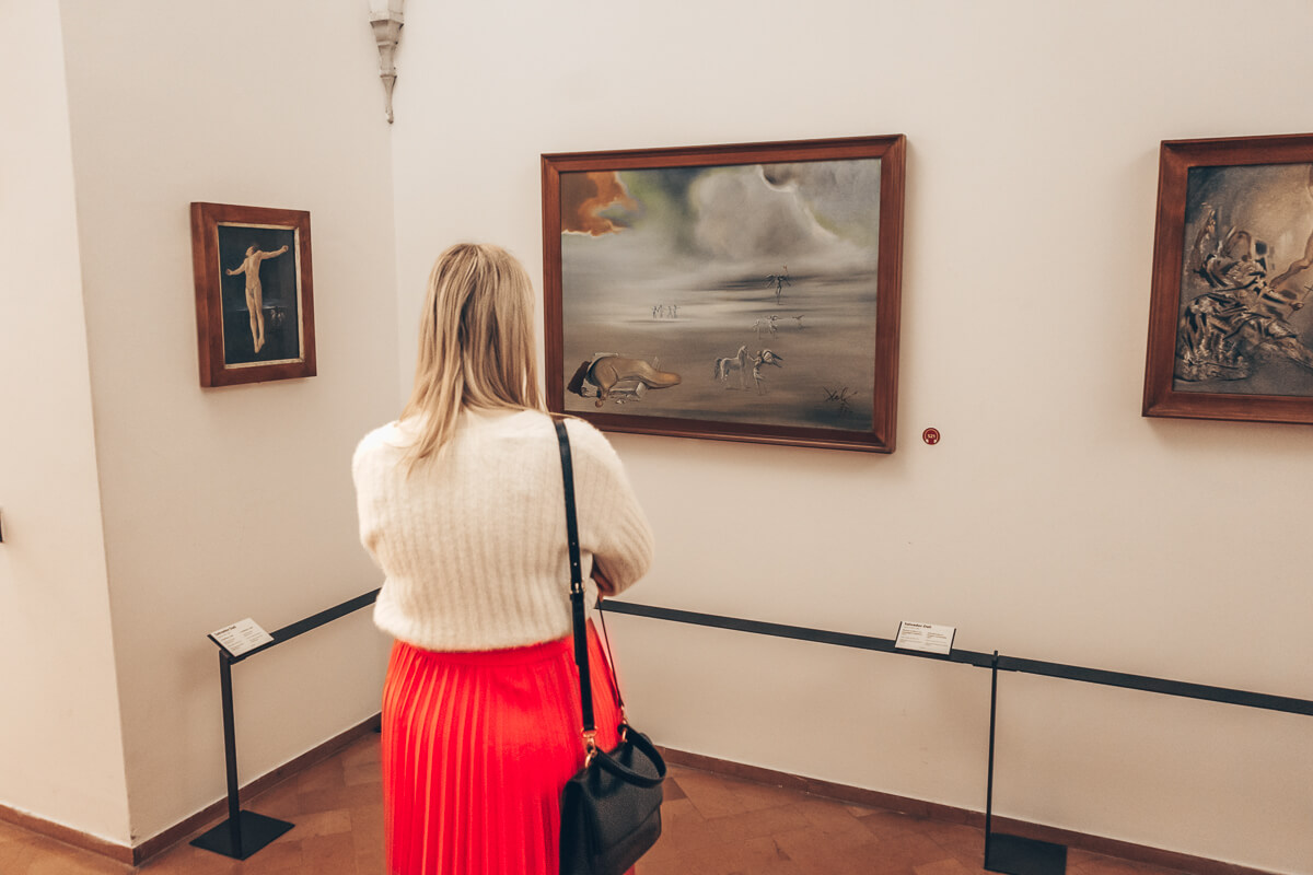 Woman admiring various artworks of the Pinacoteca gallery inside the Vatican Museums