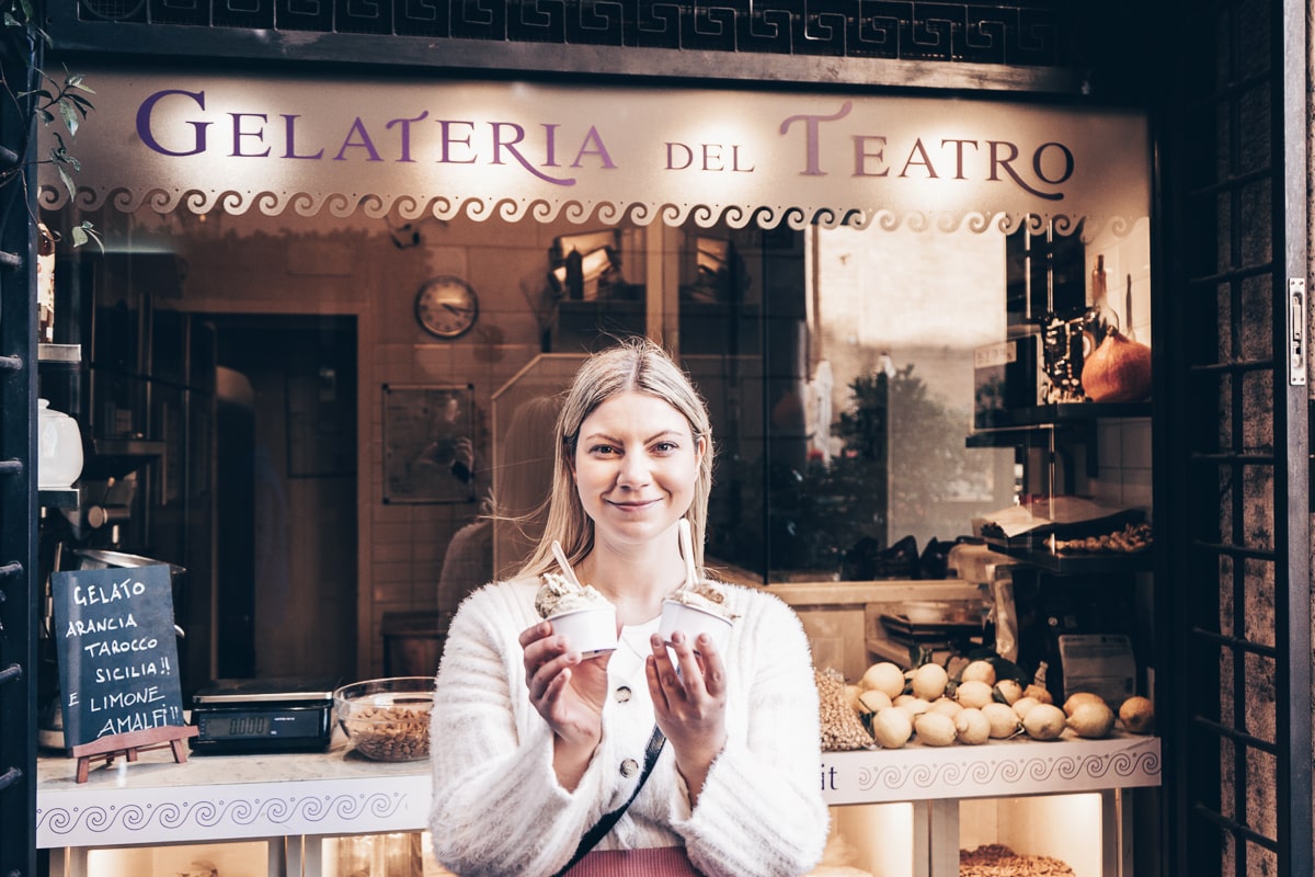 Gelato - A beautiful woman standing in front of the famous Gelateria del Teatro in Rome, Italy