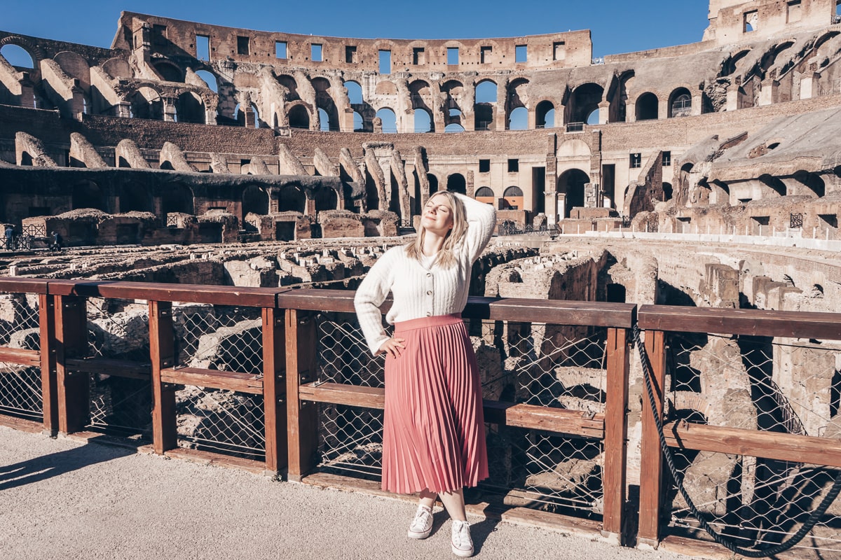 Rome sightseeing: A beautiful woman posing for a photo on the Colosseum arena floor