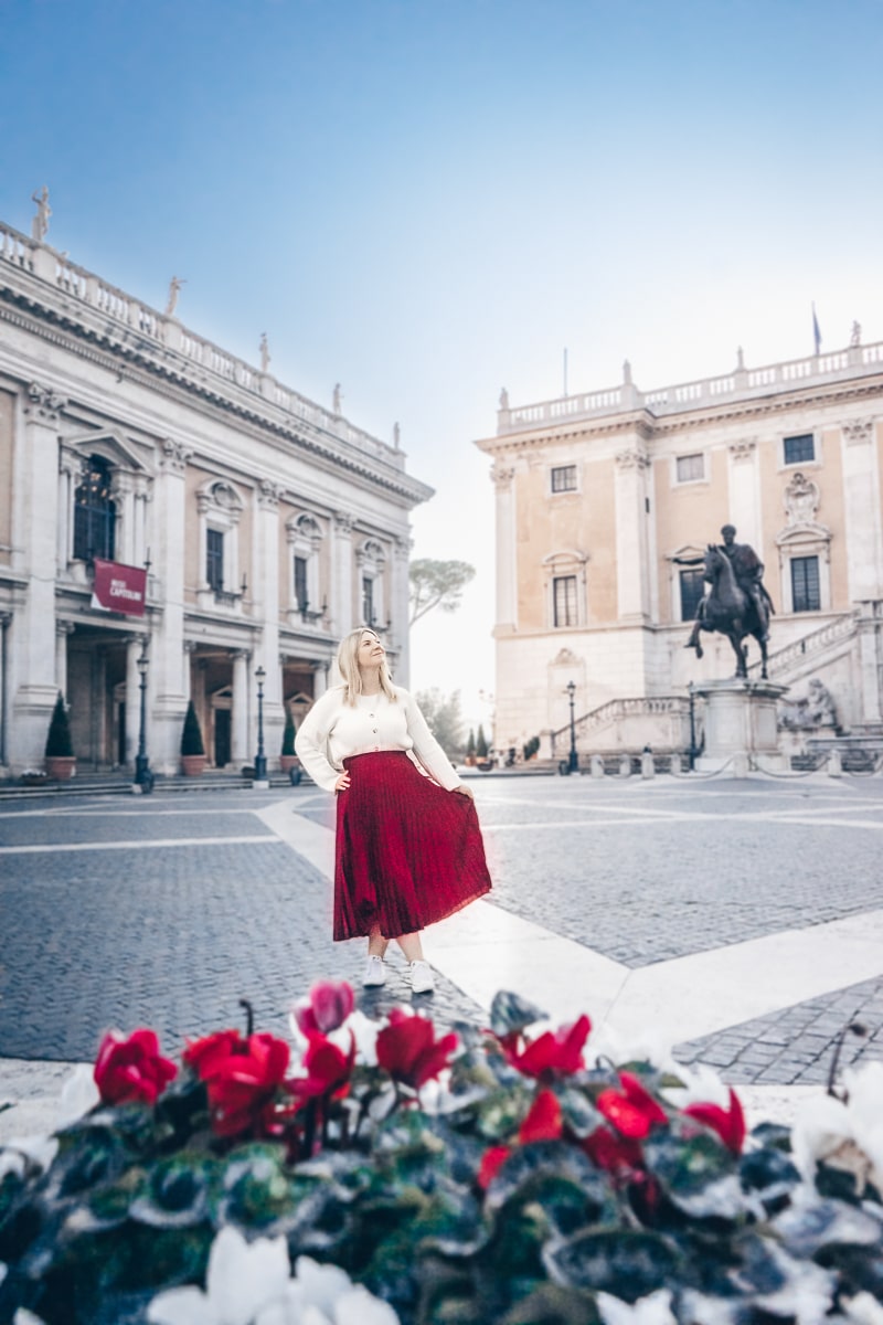 Instagram worthy places in Rome: A woman posing for a picture at the Capitol Square in the early morning