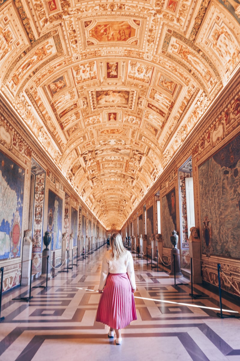Vatican Museums Rome: A woman posing for a picture in the famous Gallery of the Maps