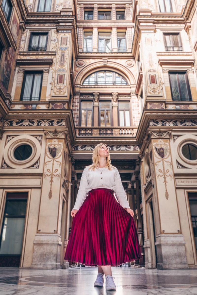 Best Rome photo spots: A woman posing for a photo in the colorful Sciarra Gallery (Galleria Sciarra)