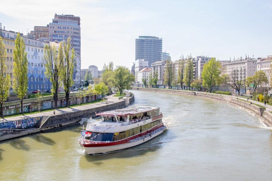 Vienna attractions: A boat sailing along the Danube on a clear summer day