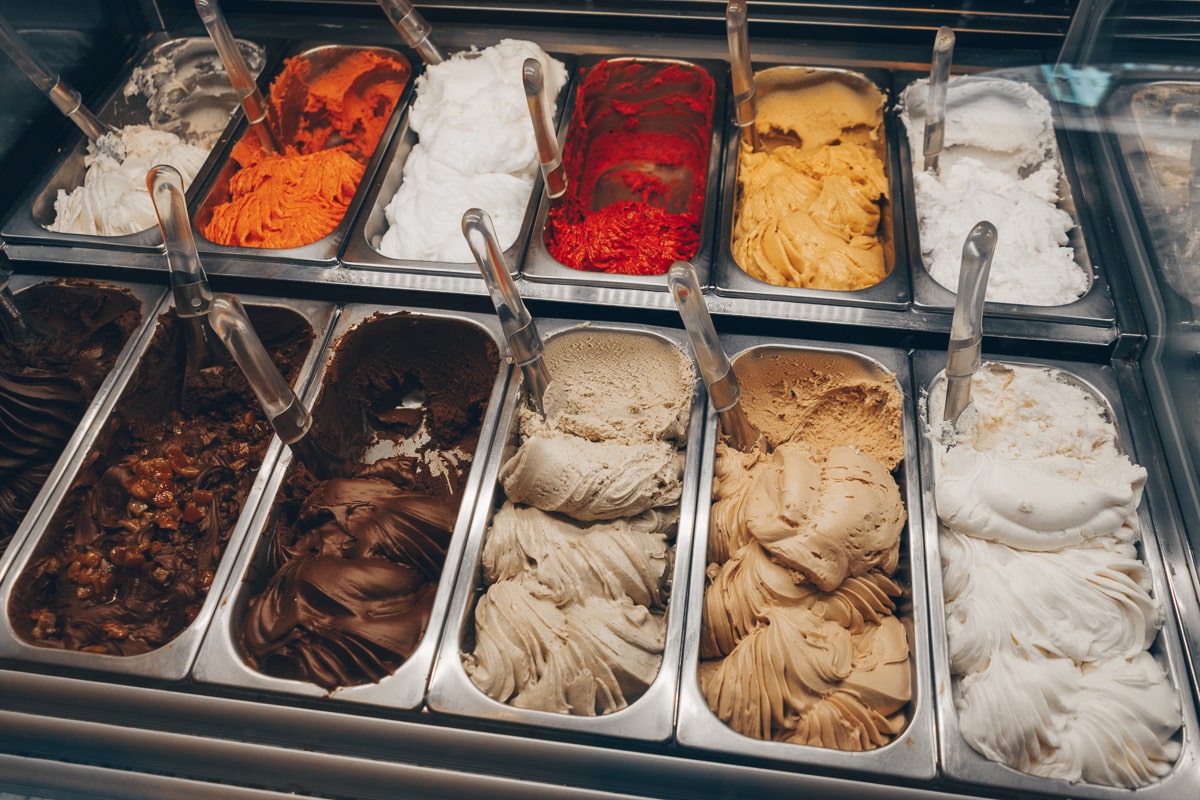 Gelato Italy: Various gelato flavors behind a counter in a gelato shop in Rome