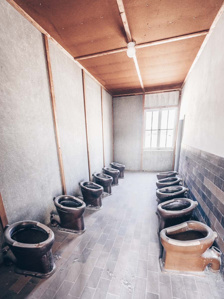 The unsanitary toilets in the interior of the Dachau Concentration Camp barracks