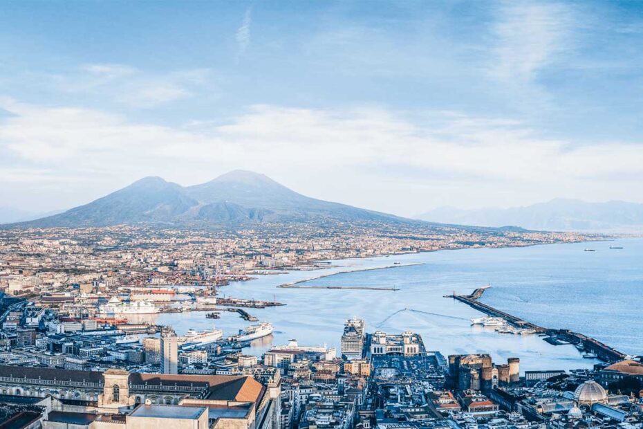 Things to do in Naples: Panorama of Naples and Mt. Vesuvius in the background at sunset